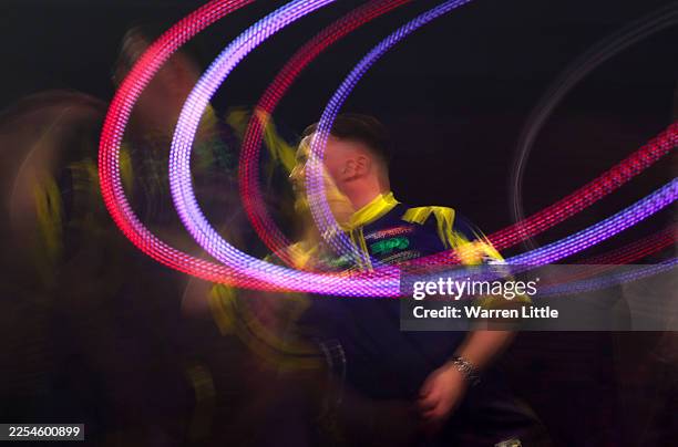 Luke Littler of England throws against Gian van Veen of the Netherlands during the 2025/26 Paddy Power World Darts Championship Final match between...