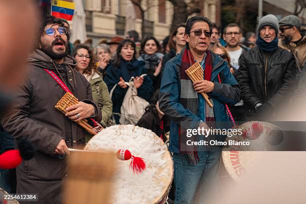 Protester play traditional Latin-America indigenous music during a protest against the capture of Nicolas Maduro in front of the US Embassy on...