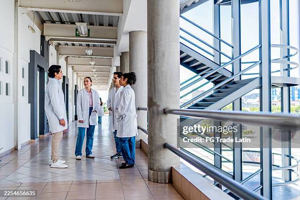 young medical students talking at university - medical school stock pictures, royalty-free photos & images