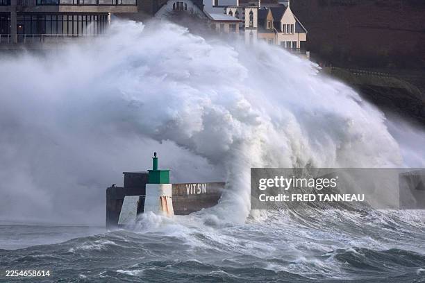 Huge wave crashes on the jetty of the harbor of Le Conquet, western France on January 8, 2026 as storm Goretti is announced to approach France's...