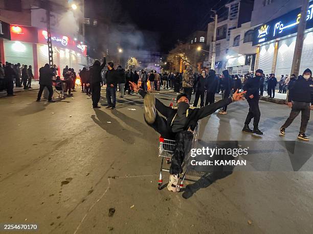 Iranians gather while blocking a street during a protest in Kermanshah, Iran on January 8, 2026. The nationwide protests started in Tehran's Grand...