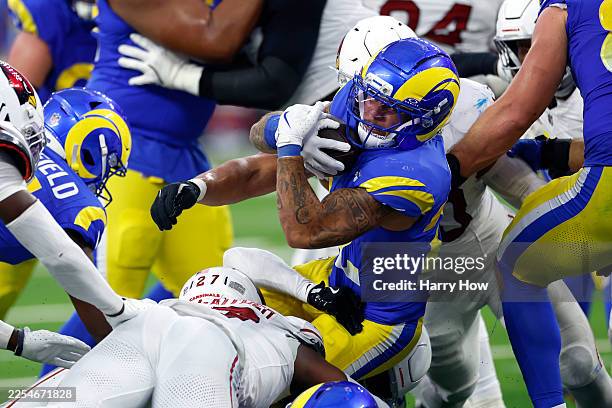 Kyren Williams of the Los Angeles Rams is tackled by Akeem Davis-Gaither of the Arizona Cardinals during the fourth quarter of the game at SoFi...