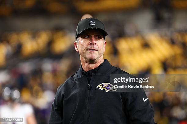 Head coach John Harbaugh of the Baltimore Ravens walks the field prior to the game against the Pittsburgh Steelers at Acrisure Stadium on January 4,...