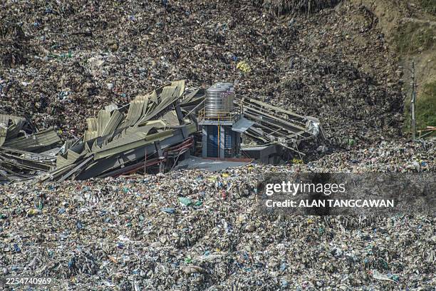 An aerial view shows a landslide at the landfill in Barangay Binaliw, Cebu City on January 9, 2026. Rescue workers searched on January 9 for dozens...