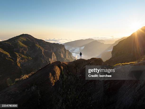 hiker on mountain ridge at sunsite, pico do arieiro, madeira - beauty in nature stock pictures, royalty-free photos & images