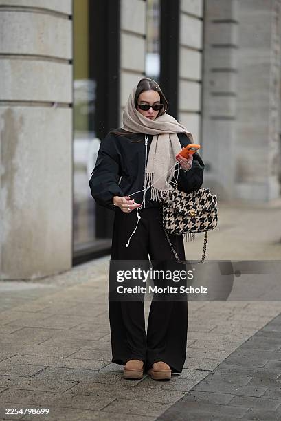 Evi Wave is seen wearing a black bomber jacket with a relaxed oversized silhouette, dropped shoulders, elasticated cuffs and a zip front closure from...