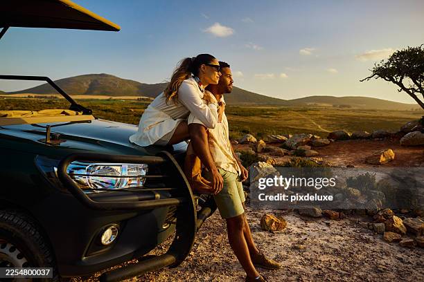 pareja disfrutando de una aventura de safari al atardecer en sudáfrica - turismo vivencial fotografías e imágenes de stock