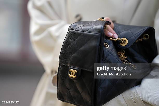 Cristina Huda attending the Munthe show during Copenhagen Fashion Week SS26, is seen wearing a Chanel 25 small bag in black and gold pleated hardware...