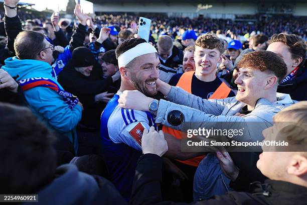 Paul Dawson of Macclesfield is mobbed by fans as he celebrates victory after the Emirates FA Cup Third Round match between Macclesfield and Crystal...