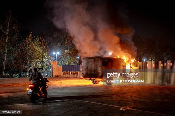 Vehicle burns during protests in Tehran, Iran, on January 8, 2026. The nationwide protests began in Tehran's Grand Bazaar in late December over...