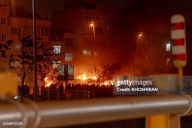 Iranians gather while blocking a street during a protest in Tehran, Iran on January 9, 2026. The nationwide protests started in Tehran's Grand Bazaar...