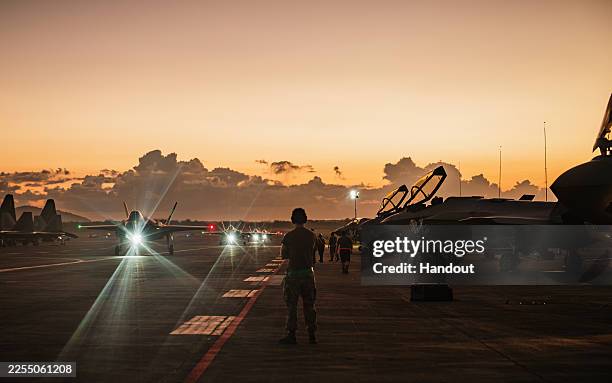 In this handout photo from the U.S. Air Force, a U.S. Air Force crew chiefs watch as F-35A Lightning II's taxi following a large-scale strike against...
