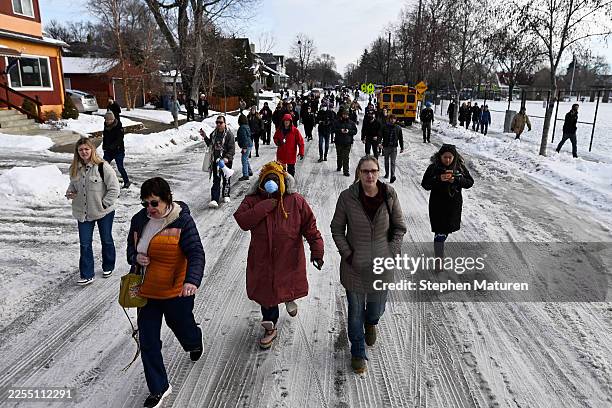 People gather near the scene of a suspected shooting by an ICE agent during federal law enforcement operations on January 07, 2026 in Minneapolis,...