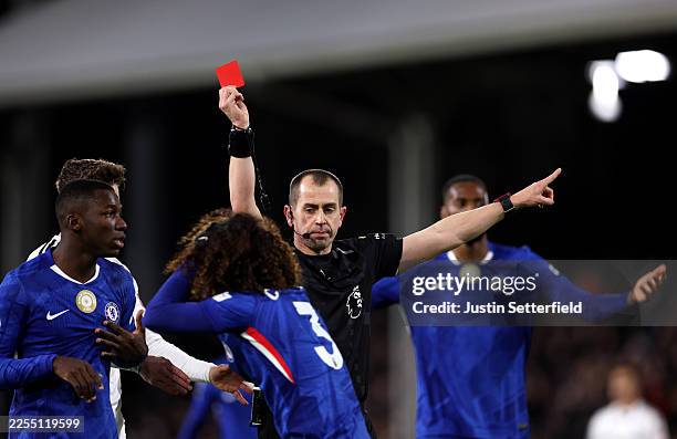 Referee Peter Bankes shows a red card to Marc Cucurella of Chelsea during the Premier League match between Fulham and Chelsea at Craven Cottage on...
