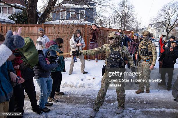 Border Patrol Tactical Unit agent sprays pepper spray into the face of a protestor attempting to block an immigration officer vehicle from leaving...