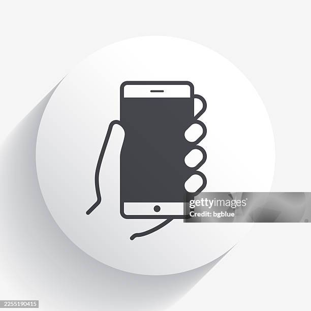 hands holding mobile phone. icon on circle button with long shadow - using tablet blank screen stock illustrations