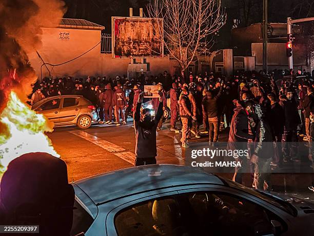 Iranians gather while blocking a street during a protest in Tehran, Iran on January 9, 2026. The nationwide protests started in Tehran's Grand Bazaar...