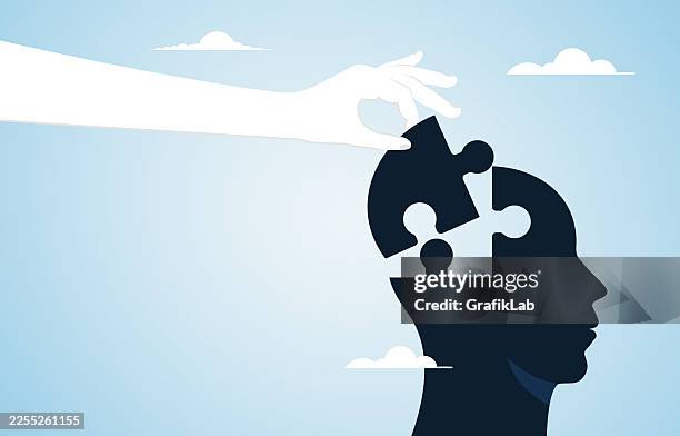 puzzle piece symbolizing thought and understanding placed on human head by hand - study guide stock illustrations