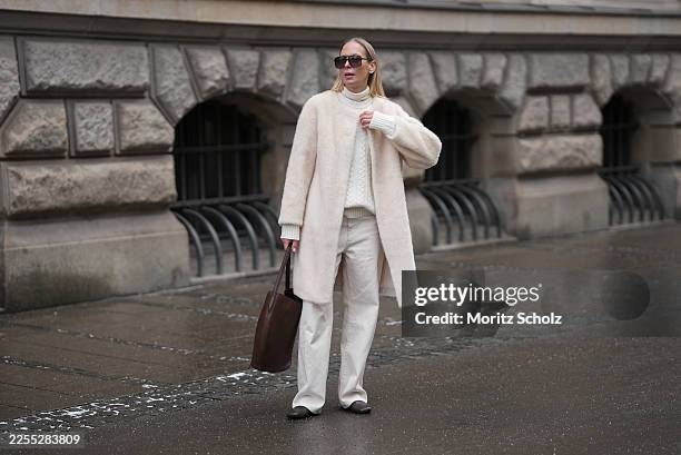 Mirja Klein is seen wearing a “Nora brushed wool coat” in a cloud dancer tone with a straight silhouette, clean open front and subtle texture from...