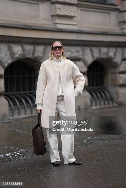 Mirja Klein is seen wearing a “Nora brushed wool coat” in a cloud dancer tone with a straight silhouette, clean open front and subtle texture from...
