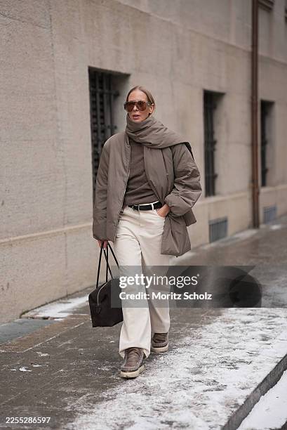 Mirja Klein is seen wearing a khaki padded jacket with an integrated scarf detail, a relaxed oversized silhouette and dropped shoulders from Arket; a...