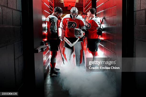 Sean Couturier, Dan Vladar and Nick Seeler of the Philadelphia Flyers stand in the tunnel before a game against the Toronto Maple Leafs at Xfinity...