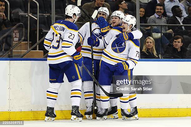 Alex Tuch, Bowen Byram, and Ryan McLeod react with Mattias Samuelsson of the Buffalo Sabres after his goal during the third period against the New...