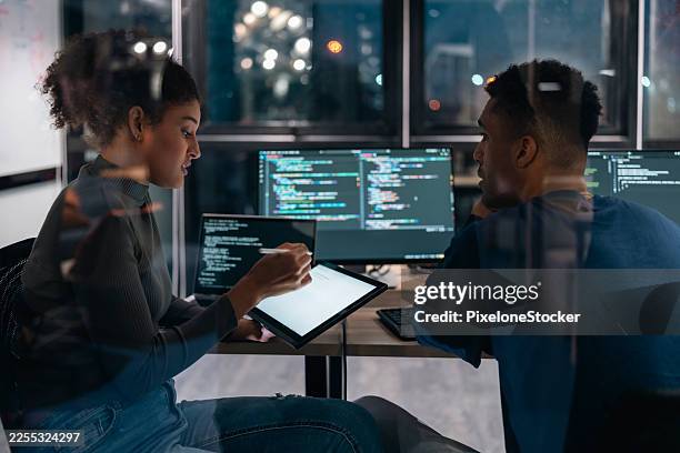 two software developers in modern office collaborating analysing the coding on computer screen. - it professional stock pictures, royalty-free photos & images