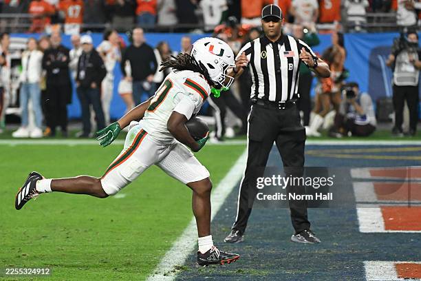Malachi Toney of the Miami Hurricanes carries the ball after a reception for a touchdown against the Ole Miss Rebels in the fourth quarter during the...