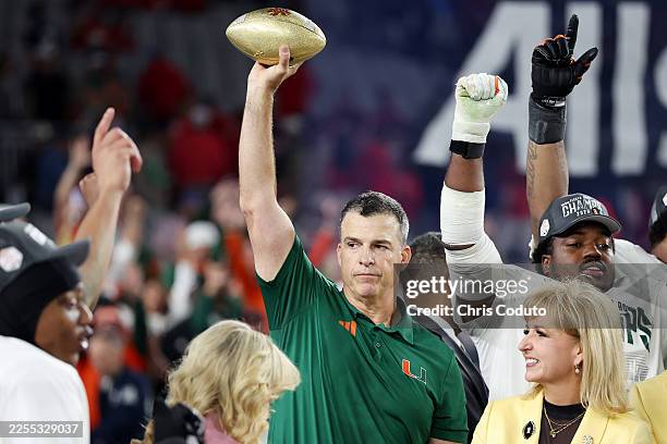 Head coach Mario Cristobal of the Miami Hurricanes lifts the trophy after the game against the Ole Miss Rebels during the 2025 College Football...