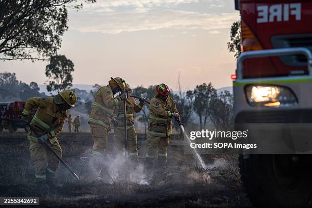 Country Fire Authority members in Alexandra work at sunset to extinguish a grass fire. On January 10 Victoria faced its most catastrophic bushfire...