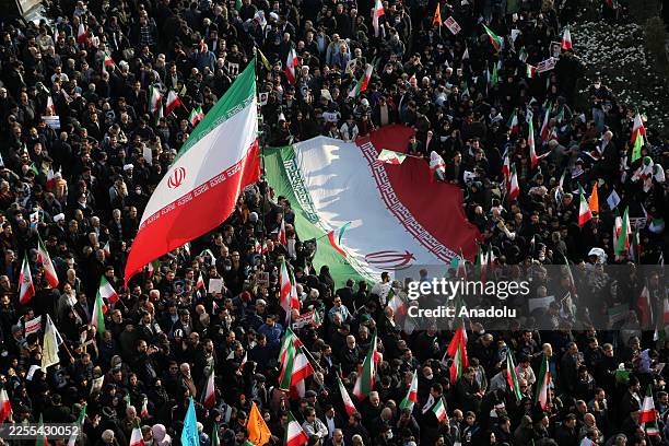 People gather at Enghelab Square after a government call to rally against recent protests across the country, chanting anti-U.S. And anti-Israel...