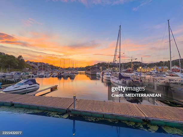 kristiansund harbor in norway with fishing boats and sailboats at sunset dusk - marina stock pictures, royalty-free photos & images