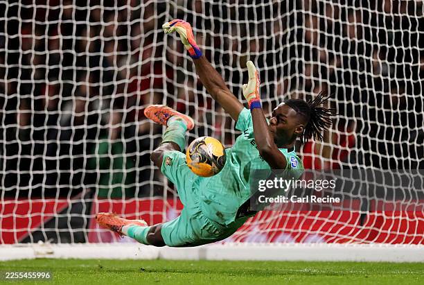 Arthur Okonkwo of Wrexham saves the fifth penalty from Omari Hutchinson of Nottingham Forest in the penalty shoot out during the Emirates FA Cup...