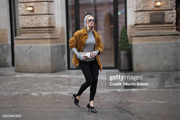Olga Loeffler is seen wearing a mustard yellow cotton corduroy puffer jacket with buttoned front, classic collar and golden metal logo patch at the...
