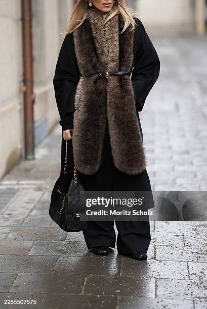 Oeznur Sinani alias Sinperi is seen wearing a long black wool coat from Max Mara; wide-leg black tailored trousers with relaxed fit from COS; black...