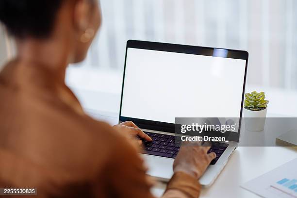 latin businesswoman working on laptop and digital tablet, dealing with finances and investments. focus on device screen - device screen office setting stock pictures, royalty-free photos & images