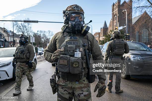 Federal law enforcement agents during a raid in south Minneapolis, Minnesota, US, on Tuesday, Jan. 13, 2026. Minnesota officials are suing over the...
