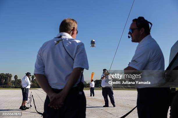 Gardena, CA Goodyear crew members Eddie Rodriguez, Steve Dien, Eddie Duran, Fabian Ochoa, and Brandon Challman prepare for the Goodyear blimp to land...
