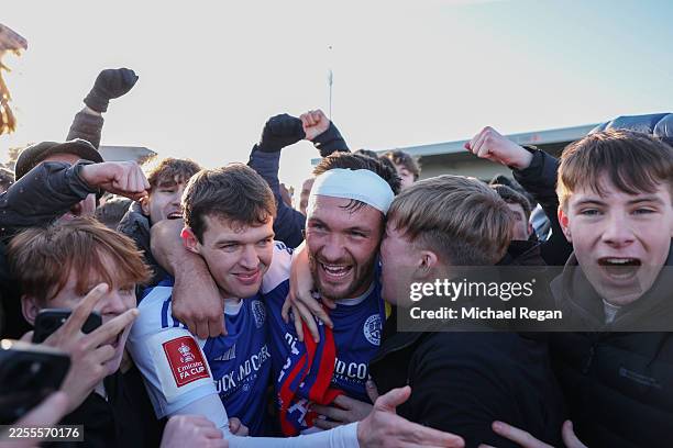 Paul Dawson of Macclesfield celebrates with team mate Luke Duffy and fans after the team's victory following the Emirates FA Cup Third Round match...