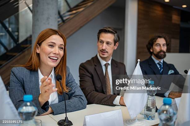 woman speaking at political conference with international delegates - ambassador stock pictures, royalty-free photos & images