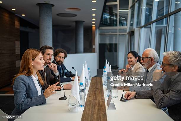 politicians negotiating during international political summit conference - diplomacia imagens e fotografias de stock