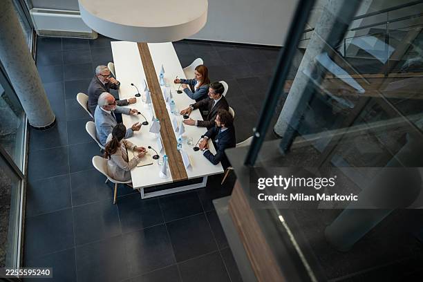 group of diplomats negotiating during international political summit - ambassador stock pictures, royalty-free photos & images