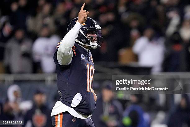 Caleb Williams of the Chicago Bears celebrates a touchdown by D'Andre Swift against the Green Bay Packers during the fourth quarter in the NFC Wild...
