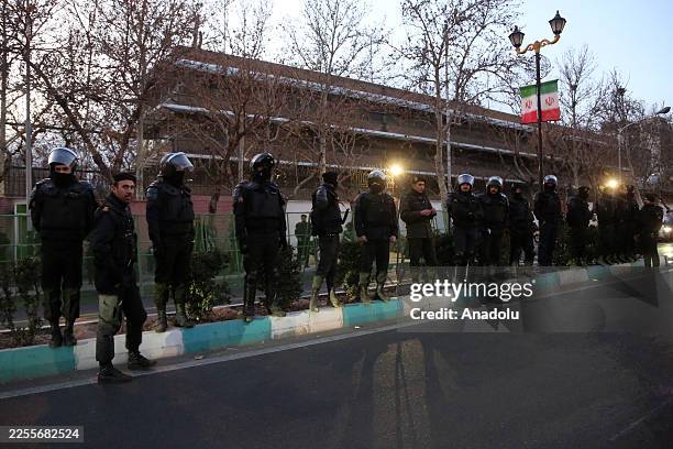 Demonstrators gather in front of the United Kingdom Embassy chanting anti-UK and anti-US slogans as Iranian security forces take measures during a...