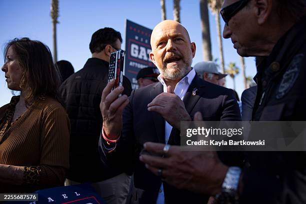 Huntington Beach, CA California Governor candidate Steve Hilton, left, records a video for a supporter after Michael Gates' press conference at...