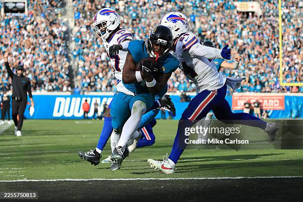 Travis Etienne Jr. #1 of the Jacksonville Jaguars runs for a touchdown during the fourth quarter against the Buffalo Bills in the AFC Wild Card...