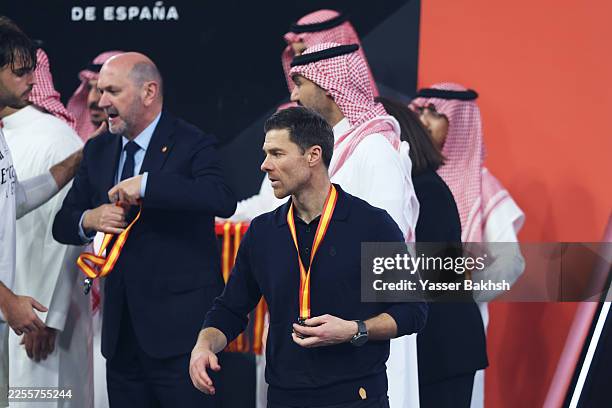 Xabi Alonso, Head Coach of Real Madrid, walks with their runners up medal around their neck following their side's loss in the Spanish Super Cup...