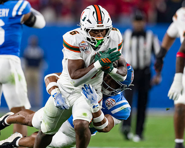 Charmar Brown of the Miami Hurricanes runs with the ball in the first quarter of the 2025 College Football Playoff Semifinal at State Farm Stadium on...
