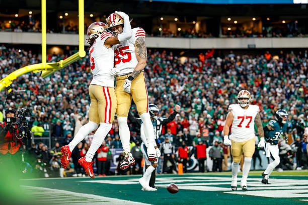 Demarcus Robinson and George Kittle of the San Francisco 49ers celebrate during the first quarter of the NFC Wild Card playoff game against the...